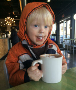 Boy drinking cocoa at Carma Coffee in Minneapolis Minnesota