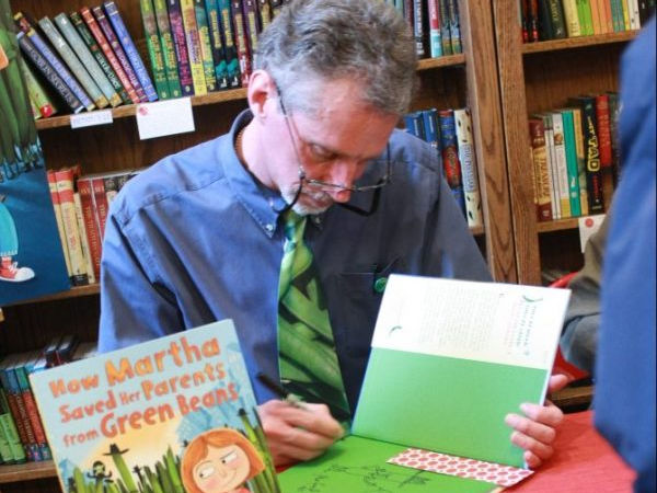 Author David LaRochelle autographing book, How Martha Saved Her Parents from Green Beans
