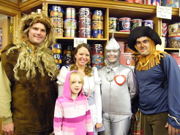 Girl poses with the Cowardly Lion, Dorothy, the Tin Man and Scarecrow at CandyLand Candy Store in Saint Paul, Minnesota