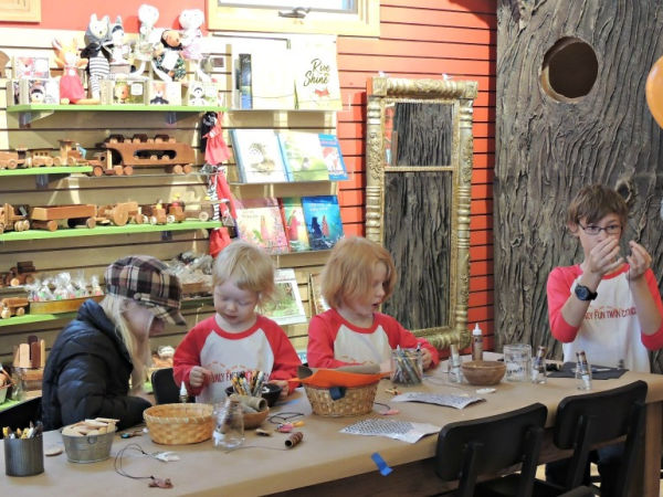 Four kids creating crafts at Heartfelt Craft store in the Linden Hills neighborhood of Minneapolis, MN