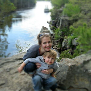 Mother and toddler son posing above the St. Croix River during a hike