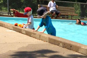 Two boys playing in the wading pool at Loring Park in Minneapolis.