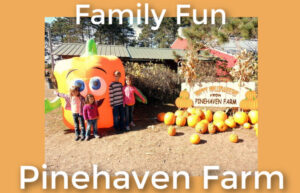 Kids standing in front of inflated pumpkin character at Pinehaven Farm in Wyoming Minnesota
