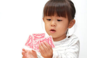 Girl holding a hand of playing cards