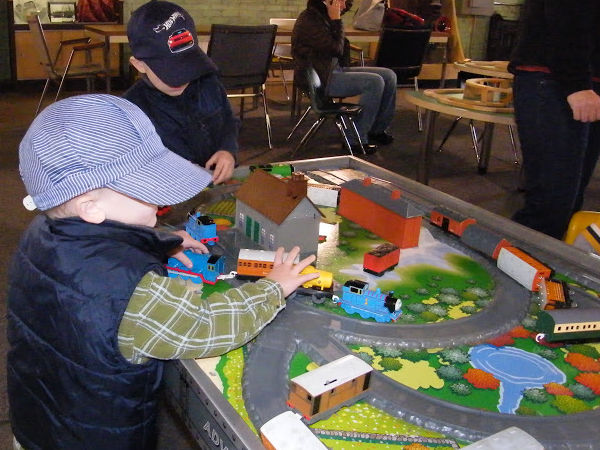 Toddler playing with trains at Jackson Street Roundhouse in Saint Paul