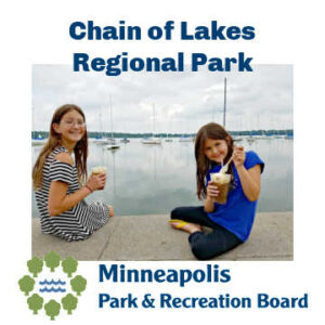 Two girls eating ice cream floats overlooking Lake Harriet in Minneapolis, Minnesota. Text: Chain of Lakes Regional Park Minneapolis Park & Recreation Board.