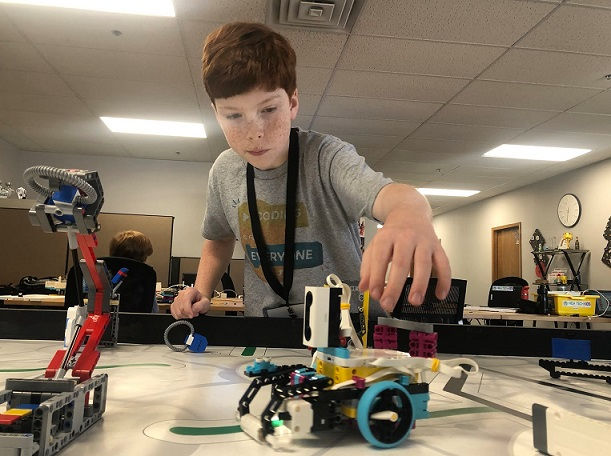 white boy building a LEGO robot