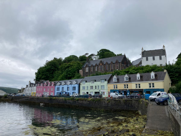 Colorful buildings lining the shoreline of Portree Harbor in the Isle of Skye