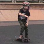 Girl on skateboard in skate park.