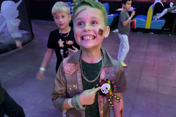 Boy showing off his Halloween costume during Urban Air's Trick or Treat Trail