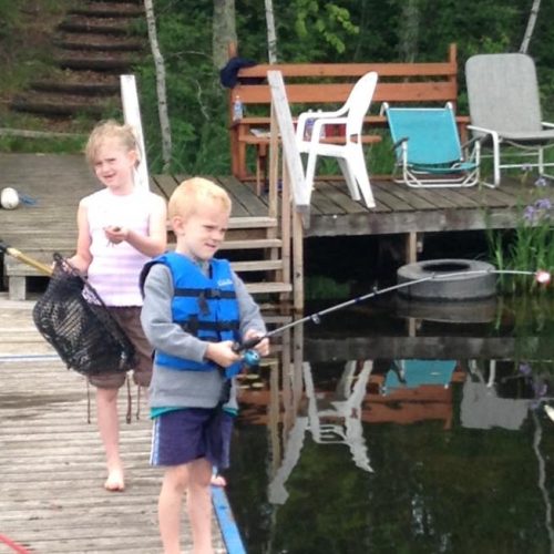 Two kids fishing from a dock